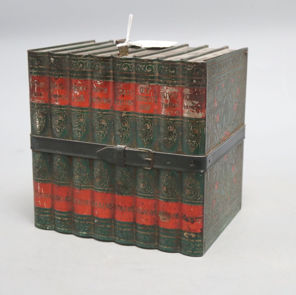 A biscuit tin in the form of eight leather bound Old Curiosity Shop books, (Huntley and Palmer), height 16cm